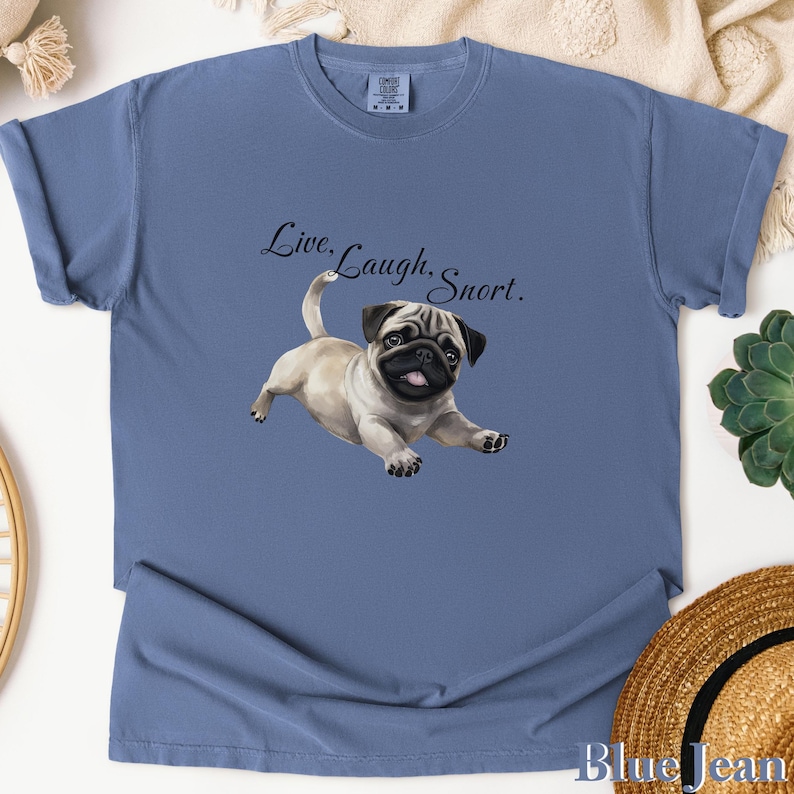 May include: A blue t-shirt with a pug illustration and the text "Live, Laugh, Snort."