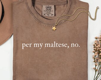 May include: An espresso-colored t-shirt featuring the white text 'per my maltese, no.' printed on the front. The shirt has a Comfort Colors label at the neckline. A gold-toned chain necklace with a small star pendant rests on the fabric.