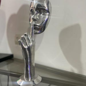 Silver Face with Finger to Lips Statue - Silent Reflection