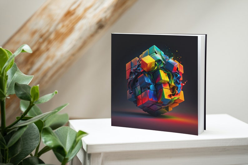 May include: A colorful cube with a swirling paint effect, printed on the cover of a square hardcover book.