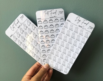 May include: Three white printable sticker sheets with black outlines of a cat, dog, and bowl. The sheets are labelled "Cat Fund", "Dog Fund", and "Pet Fund". Each sheet has a goal section and a section labelled "EACH" with a small icon of the animal or bowl. The sheets are designed for budgeting and saving for pet expenses.