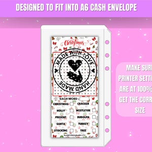 May include: A white insert with a Christmas-themed word search puzzle, designed to fit an A6 cash envelope. The insert features the text "Christmas" and "Made With Love" with a heart graphic. The text "Make sure printer settings are at 100% to get the correct size" is also included.