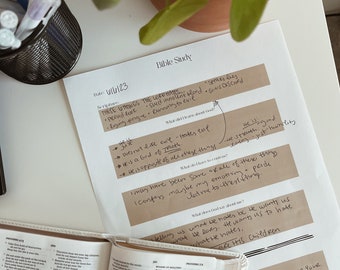 May include: A Bible study setup with an open Bible, handwritten notes, and a potted plant. The notes include the text "THESE THINGS THE LORD HATES" and other scriptural references. Pens are in a black wire cup.