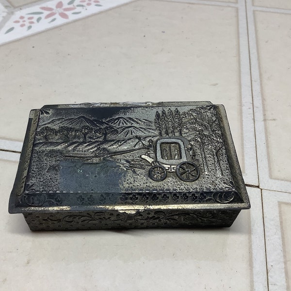 Vintage silver trinket jewelry pill box with lid. Made in Japan with embossed horse and carriage scene. Research appears to be circa 1950s