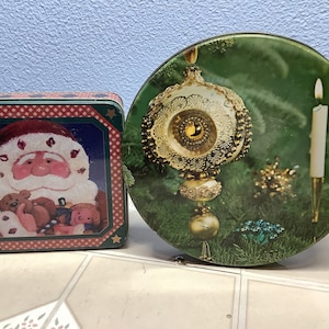 Christmas scene tins vintage 8 inch round from 1976 when I bought first home 6 inch square tin has Santa with toys  brings back memories