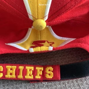 May include: Red and yellow baseball cap with a white star and the word "CHIEFS" embroidered in yellow on the front.