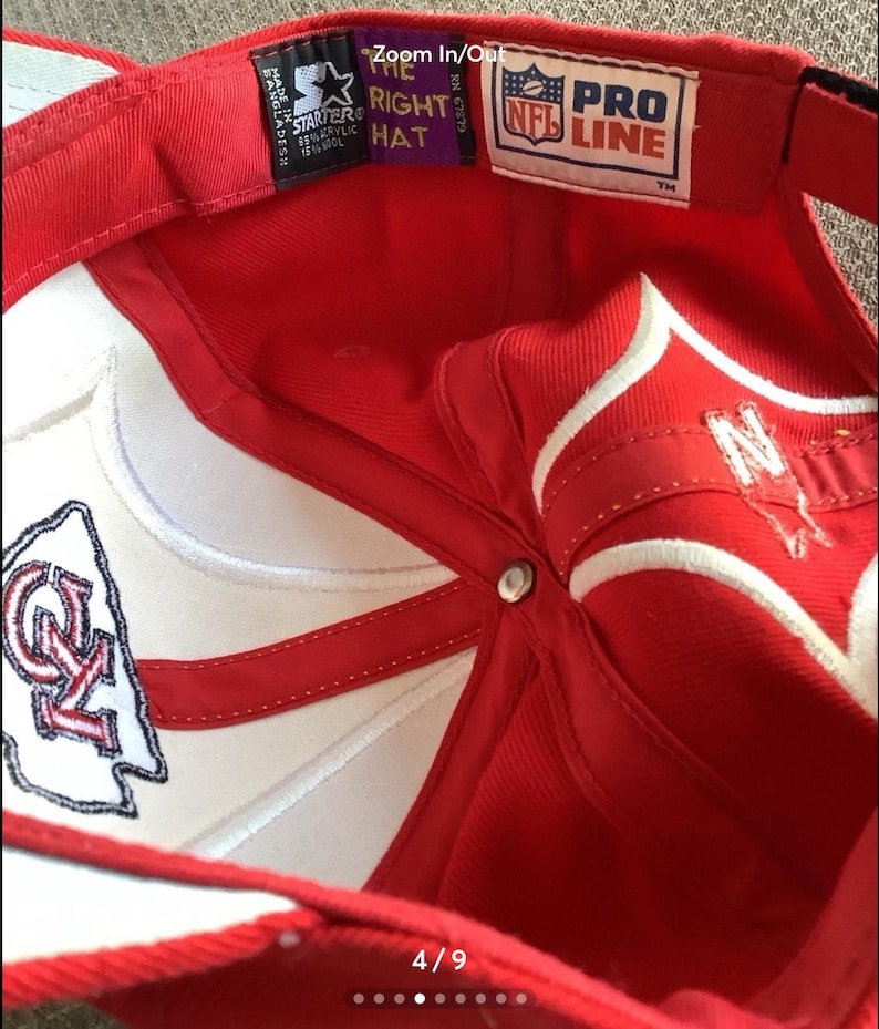 May include: Red and white baseball cap with a white NFL Pro Line logo and a red and white Kansas City Chiefs logo. The cap has a white adjustable strap with a black buckle.