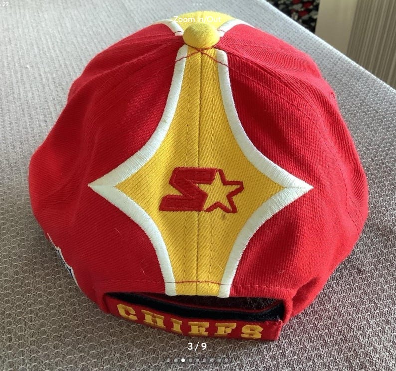 May include: Red baseball cap with a yellow star and the word "Chiefs" on the back. The cap has a white star and the letter "S" on the front.
