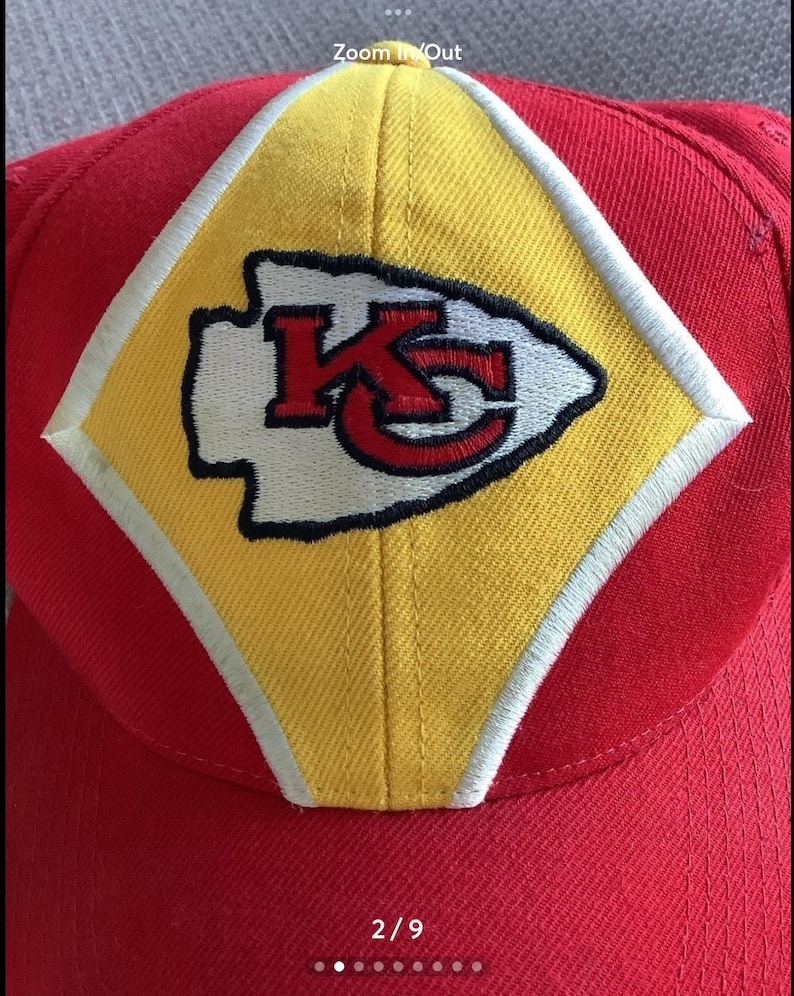 May include: Red and yellow baseball cap with a white and red embroidered Kansas City Chiefs logo. The logo features the letters "KC" inside an arrowhead.