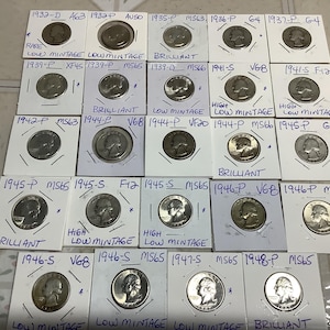 May include: A collection of twenty-two silver quarters housed in individual white cardboard coin flips. Each flip is labeled with handwritten ink detailing the year, mint mark, and grade, such as 1932-D, 1946-S, and MS65, with some marked as brilliant or low mintage.