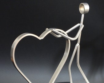 Stainless steel figure with heart "the holder"