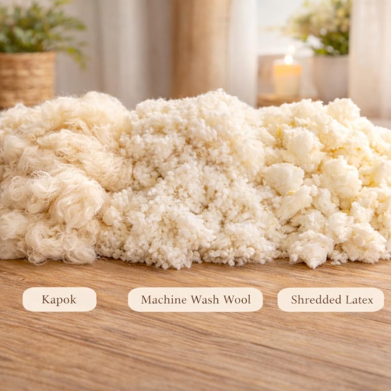 May include: An image showcasing three different types of pillow fill: Kapok, Machine Wash Wool, and Shredded Latex. The Kapok appears as loose, light-colored fibers. The Machine Wash Wool is a fluffy, white material. The Shredded Latex is a chunky, off-white fill.