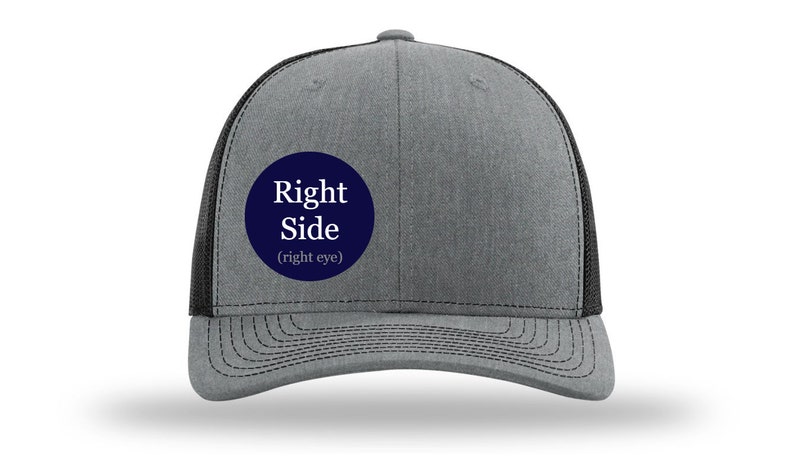 May include: A gray and black trucker hat with a navy blue circle patch that says "Right Side (right eye)".