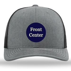 May include: A gray and black trucker hat with a navy blue circle patch that says "Front Center" in white text.
