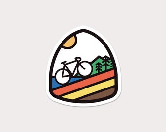 May include: A sticker featuring a colourful illustration of a bicycle riding through a landscape with a sun, trees, and a blue river. The sticker is shaped like a teardrop.
