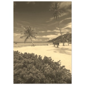 May include: A sepia toned photograph of a tropical beach with two palm trees and a wooden sign. The beach is sandy and there is a small boat in the water.