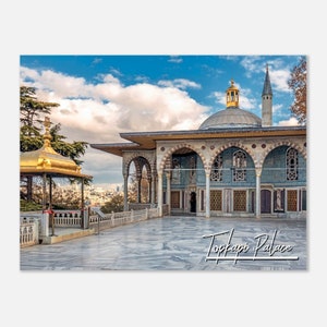 May include: A view of the Topkapi Palace in Istanbul, Turkey. The palace is a large, ornate building with a blue and white tiled exterior. The palace is surrounded by a courtyard with a marble floor. The sky is blue with white clouds.