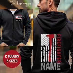 May include: Black zippered hoodie with a red and white American flag design on the back. The flag has a red axe and the text "FIREFIGHTER" and "NAME" on it. The hoodie is available in 2 colors and 5 sizes.