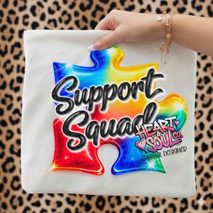 May include: White tote bag with a colourful jigsaw piece design and the words "Support Squad" in black script. The design includes the text "Heart & Soul Co. Original Designer."