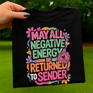 May include: Black t-shirt with the text "MAY ALL NEGATIVE ENERGY BE RETURNED TO SENDER" in colorful, stylized lettering. The design includes floral and heart accents, with a circular "ORIGINAL HEART & SOUL DESIGNS" stamp.