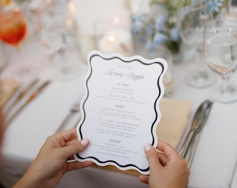 Puede incluir: Un menú de boda blanco con texto negro y un borde decorativo. El menú enumera las opciones de bienvenida, para empezar, entrada y postre. El menú está titulado "Bienvenido a Journey Riggin".