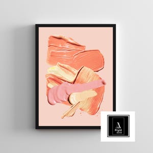 May include: Abstract art print in a black frame. The artwork features layered brushstrokes in shades of peach, pink, and cream against a pale pink background. The lower right corner displays a logo with the text "Art Prynt Able".