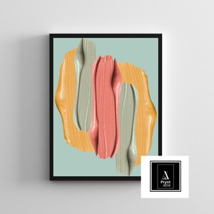 May include: Abstract art print featuring brushstrokes in shades of peach, yellow, and gray against a light blue background. The artwork is framed in a black frame. The lower right corner has a logo with the text "Pryntable".