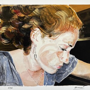 May include: A watercolour painting of a woman with long, reddish-brown hair. She is wearing a blue shirt and has a necklace on. The painting is signed "Emmanuel" in the bottom right corner and "1/30" in the bottom left corner.