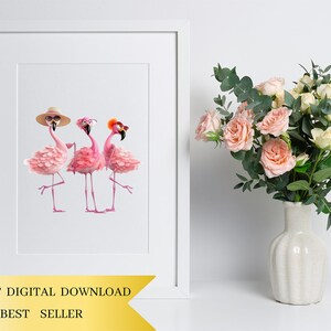 a vase of flowers next to a picture of two flamingos