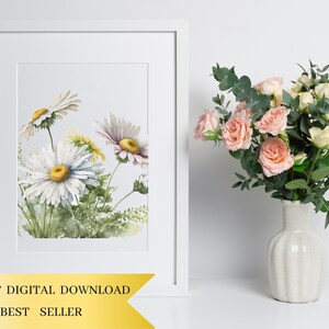 May include: A watercolour painting of a bunch of white daisies with yellow centres. The daisies are painted in a realistic style with delicate details. The painting is framed in a white frame and is displayed on a white wall.