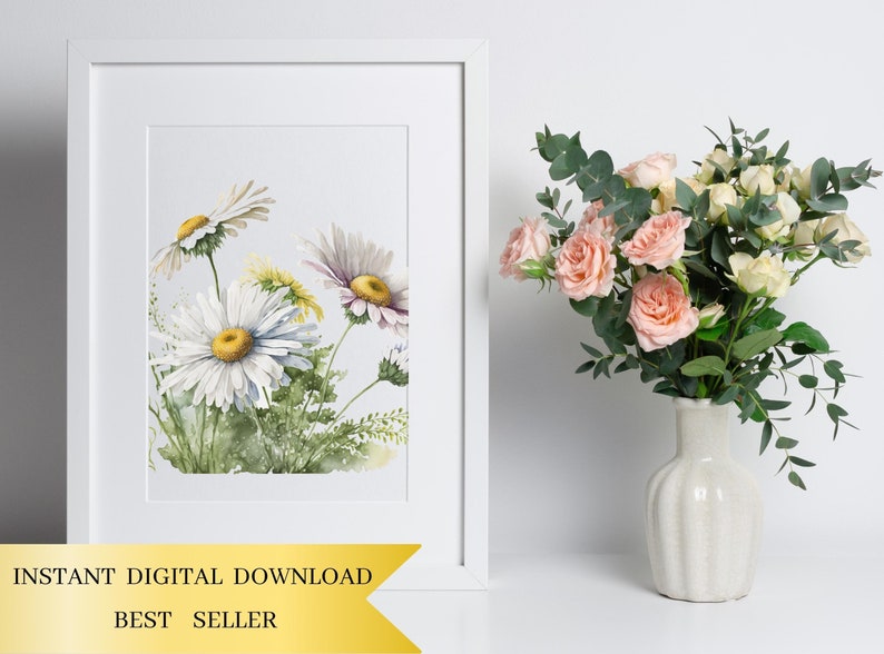 May include: A watercolour painting of a bunch of white daisies with yellow centres. The daisies are painted in a realistic style with delicate details. The painting is framed in a white frame and is displayed on a white wall.