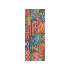 May include: A rectangular patchwork textile featuring a variety of colorful fabric squares. The squares display floral, paisley, and geometric patterns in shades of red, blue, orange, and green. The textile is likely a decorative item.