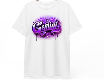 May include: White t-shirt with a purple and magenta Gemini graphic. The word "Gemini" is written in a graffiti style with dripping paint effect. The design includes the Gemini zodiac symbol.