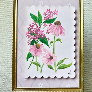 May include: A framed painting of pink flowers with green leaves. The flowers are painted in a realistic style and are arranged in a bouquet. The painting is set against a light pink background with a white scalloped border.
