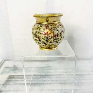 May include: A white ceramic mug with a black handle and the text "But first, coffee" in a handwritten style. The mug is on a white surface. The mug is 4 inches tall.