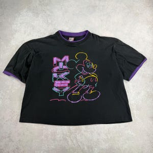May include: Black t-shirt with a Mickey Mouse graphic and the word "Mickey". The shirt has a purple collar and sleeve trim. The graphic is outlined in neon colours.