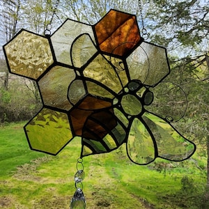 Stained glass sun catcher, bee hive with a beveled bumble bee sitting on top of hive. Clear bee wings with decorative etching
