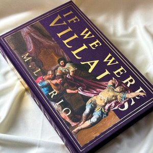 May include: A purple hardback book with gold lettering that reads "If We Were Villains" by M.L. Rio. The cover features a painting of a scene from a play.
