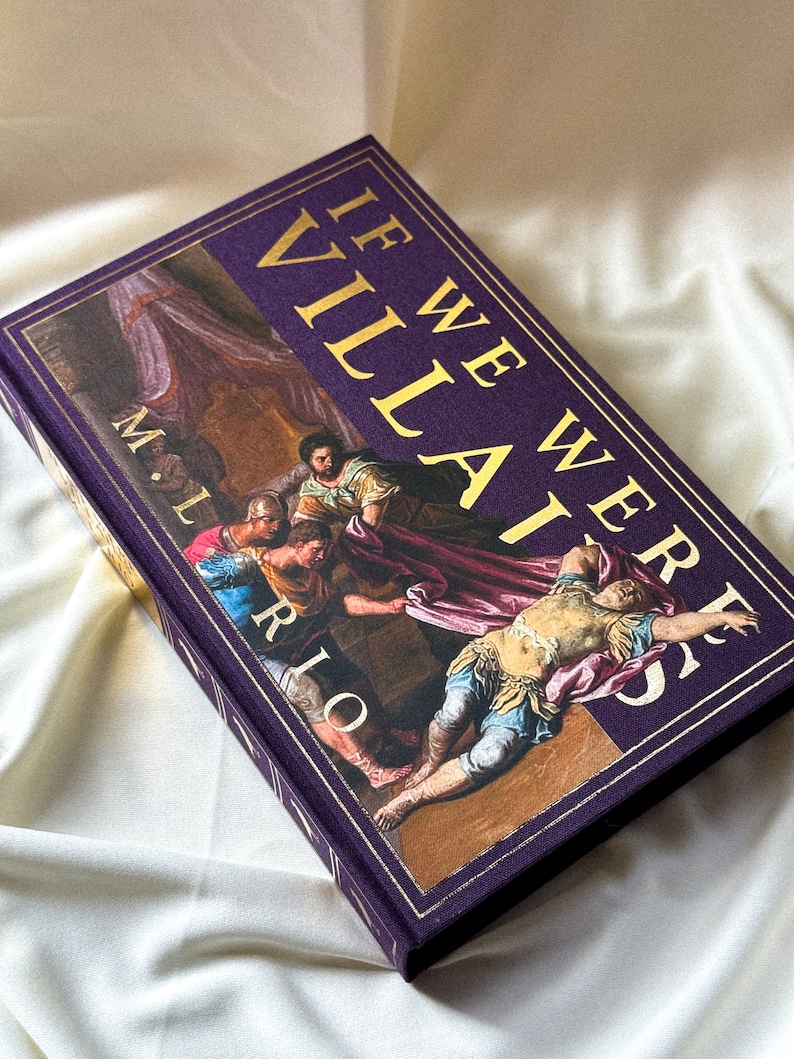 May include: A purple hardback book with gold lettering that reads "If We Were Villains" by M.L. Rio. The cover features a painting of a scene from a play.