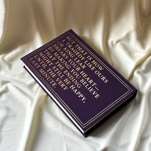 May include: A purple hardback journal with gold lettering that reads "But that is how a tragedy like ours or King Lear breaks your heart - by making you believe that the ending might still be happy, until the very last minute."