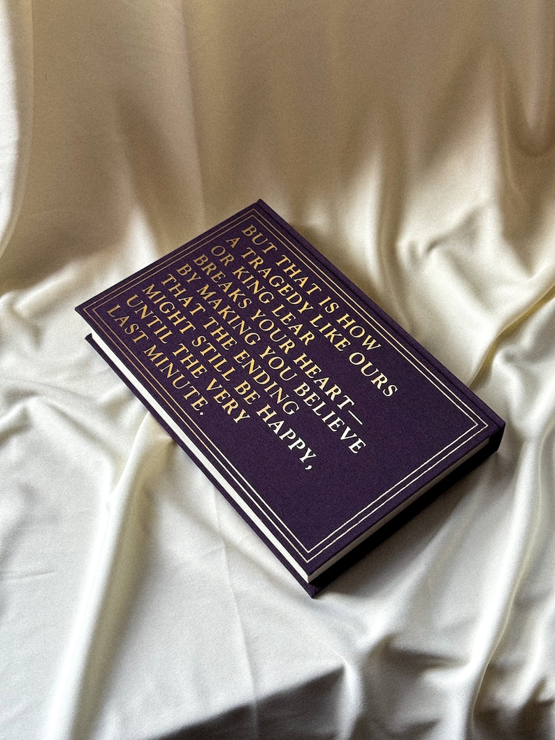 May include: A purple hardback journal with gold lettering that reads "But that is how a tragedy like ours or King Lear breaks your heart - by making you believe that the ending might still be happy, until the very last minute."