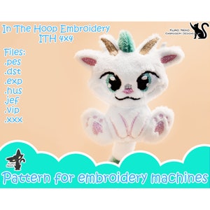 May include: White plush toy of a cat with a green and gold horn on its head. The cat is sitting with its paws in the air. The image includes the text "In The Hoop Embroidery ITH 4x4" and "Files: .pes .dst .exp .hus jef .Vip .XXX".