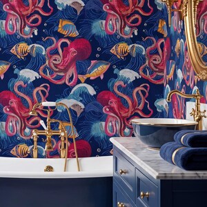 May include: A bathroom featuring wallpaper with a repeating pattern of red octopuses, yellow fish, and blue ocean waves on a dark blue background. The room includes a navy blue clawfoot bathtub with gold feet, a gold faucet, and a navy blue vanity.