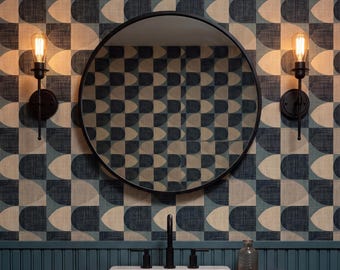 May include: A floating wooden vanity with a white rectangular sink and black faucet, mounted against a teal beadboard wall. Above, a round black-framed mirror is flanked by two wall sconces, set against wallpaper with a blue and cream geometric pattern.
