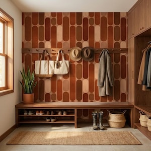 a well-organized entryway with a wooden bench, a shelf for shoes, and a wall with a patterned orange and brown design. There are two handbags hanging on the wall, and a plant is placed on the floor next to the bench.