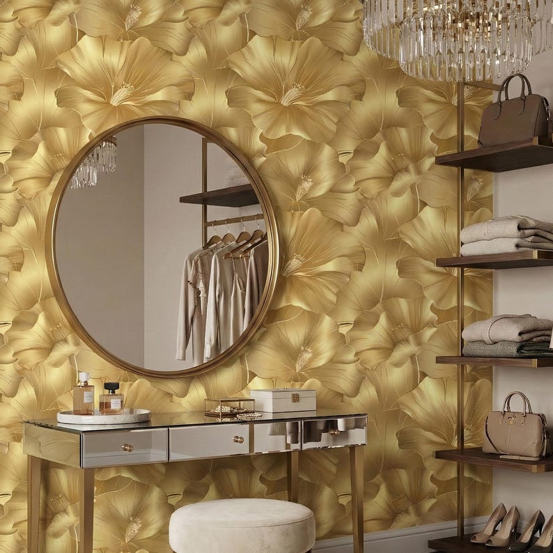 a luxurious dressing room with a gold floral wallpaper, a round mirror, a vanity with drawers, and a chandelier.