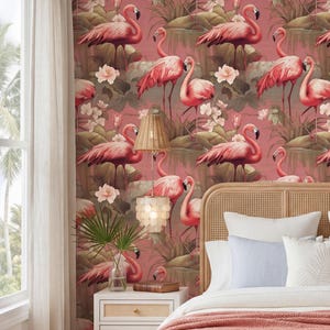 May include: A bedroom scene featuring a flamingo-themed wallpaper in shades of pink and green. The wallpaper depicts pink flamingos amidst flowers and foliage. The room includes a bed with white bedding, a rattan headboard, and a nightstand with a lamp.