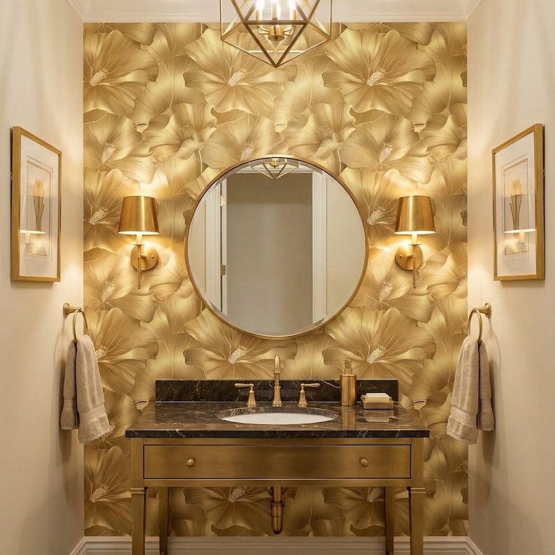 a luxurious bathroom with a gold-colored vanity, a round mirror, and gold-colored wall sconces. The walls are covered in a gold floral wallpaper, and the overall design has a warm and elegant appearance.