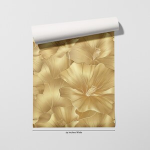 a close-up view of a gold floral pattern on a white background.