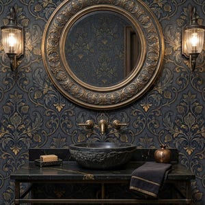 May include: A luxurious bathroom vanity with a dark granite countertop, a textured stone sink, and a large round mirror with a gold frame. The wallpaper features a dark blue and gold floral pattern. Two sconces flank the mirror.